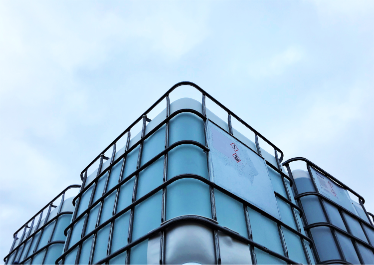 Modern architecture featuring a building with a wavy glass facade against a soft blue sky, inspired by the fluidity of marine fuel.